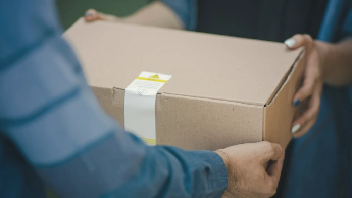 person giving brown box